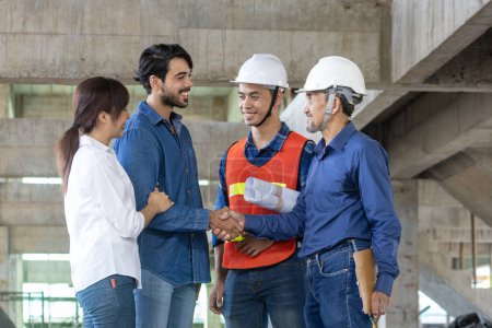Photo for Newly wed couple is handshaking with engineering contractor at the under construction house to inspect building progress and quality control for home ownership and real estate development - Royalty Free Image
