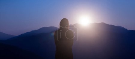 Photo for Young traveller is looking at panoramic view while exploring in the mountain area for surveying and freedom, discovering the rare biological and ecologist on the field study and outdoor at sunrise - Royalty Free Image