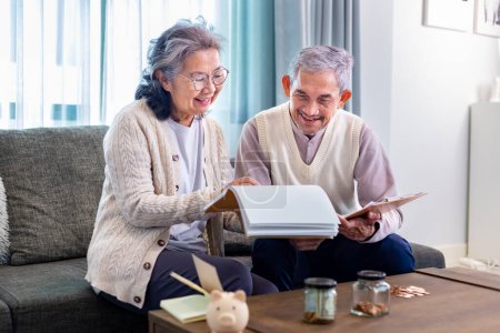 Photo for Senior Asian couple is planning on retirement saving fund looking at their income and expense and annual pension after taxes for elder long term financial investment and budget - Royalty Free Image
