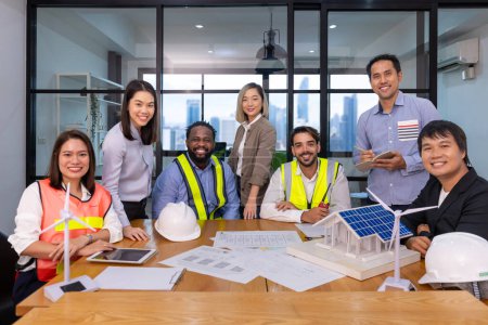 Photo for Team of architecture and engineers are discussing and brainstorming on floor plan over clean energy and power saving house design using solar panel for green industry and futuristic home development - Royalty Free Image