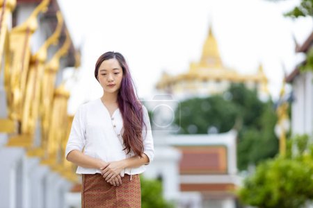 Photo for Buddhist asian woman is doing walking meditation around temple for peace and tranquil religion practice concept - Royalty Free Image