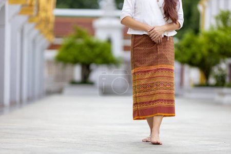 Photo for Buddhist asian woman is doing walking meditation around temple for peace and tranquil religion practice - Royalty Free Image