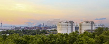 Photo for Panorama view of heavy industrial estate including crude oil industry and logistics port that located next to high density forest which create pollution and contamination to wildlife - Royalty Free Image