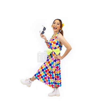 Photo for Asian hippie woman dress in 80s vintage dress fashion with colorful retro funk disco clothing while dancing isolated on white background for fancy outfit party and pop culture usage - Royalty Free Image