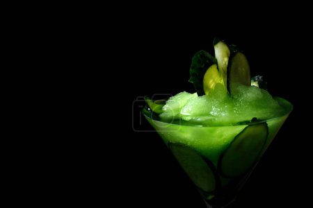 Photo for Green cocktail on the black background. With fresh cucumbers and sorbet. - Royalty Free Image