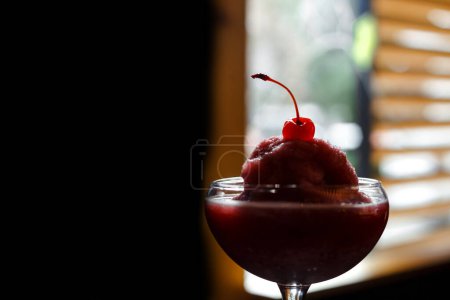 Photo for Red cocktail on the black background. With fresh cherry and sorbet. - Royalty Free Image