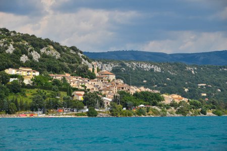 Photo for Beautiful view of Mediterranean town or village over teal blue water of sea or lake, Provence, France, low angle view, copy space - Royalty Free Image