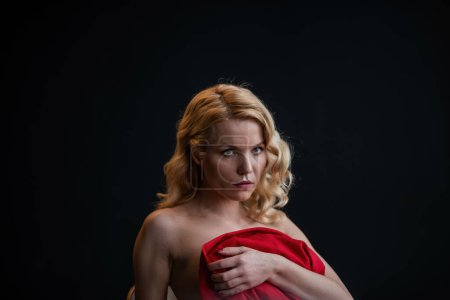 Photo for Adult beauty woman bare back in formal evening red trousers sitting pose without bra. Stylish blonde curly hair sensual nude model fashionista posing at studio in fashion pantsuit out of blazer - Royalty Free Image