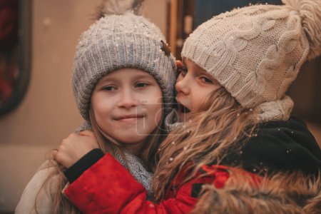 Photo for Children celebrating Christmas and New Year winter holidays season outdoor waiting Santa. Kids joyful spending time together near Xmas camper trailer rejoices at first snow enjoying childhood - Royalty Free Image