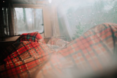 Photo for Children sleeping in Xmas camper trailer while celebrating Christmas and New Year winter holidays - Royalty Free Image