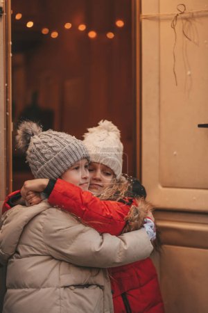 Photo for Girls celebrating Christmas and New Year winter holidays season outdoor. Little girls joyful spending time together near Xmas camper trailer. - Royalty Free Image