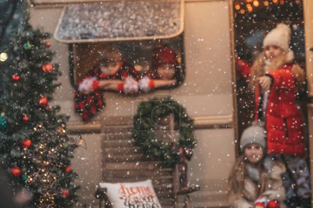 Foto de Los niños que celebran la Navidad y Año Nuevo vacaciones de invierno temporada al aire libre esperando a Santa. Niños alegre pasar tiempo juntos cerca de Navidad caravana remolque se regocija en la primera nieve disfrutando de la infancia - Imagen libre de derechos