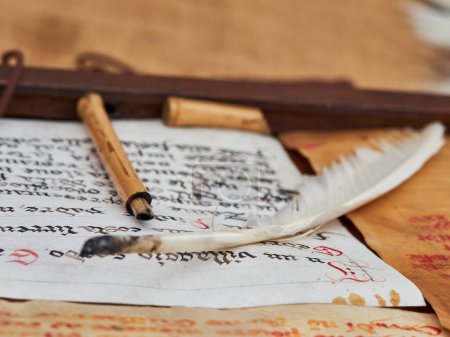 Photo for An ancient written scroll of parchment with an ancient pen - Royalty Free Image