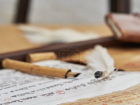 Photo for An ancient written scroll of parchment with an ancient pen - Royalty Free Image