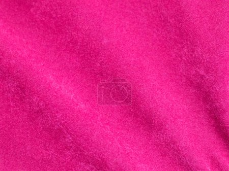 Téléchargez les photos : Texture de tissu de velours rose utilisé comme fond. Fond en tissu rose vide de matière textile douce et lisse. Il y a de l'espace pour tex - en image libre de droit
