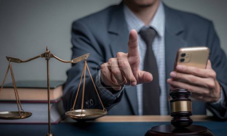 Lawyer's hand concept Justice with Judge gavel, Businessman in suit or Hiring lawyers in the digital system. Legal law, prosecution, legal adviser, lawsuit, detective, investigation,legal consultant. 