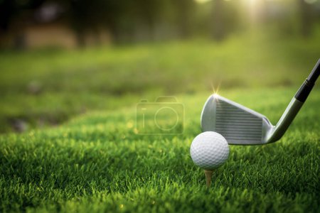 Golf ball close up on tee grass on blurred beautiful landscape of golf background. Concept international sport that rely on precision skills for health relaxation.