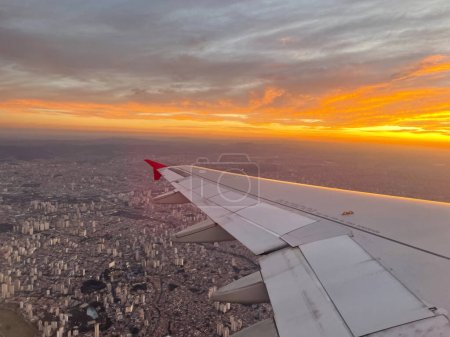 Photo for View from the window of an airplane. turbine of an airplane under the Sao Paulo, Brazil. .At the sunset. - Royalty Free Image