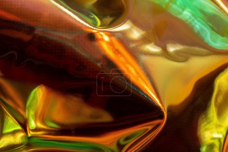 Photo for Wrinkled plastic material with an iridescent holographic surface. Multicolored background texture - Royalty Free Image