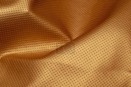 Photo for Closeup of rippled perforated leather. Golden background - Royalty Free Image