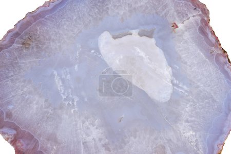Foto de A big piece of unpolished agate mineral cross section with a dull luster. Stone texture - Imagen libre de derechos