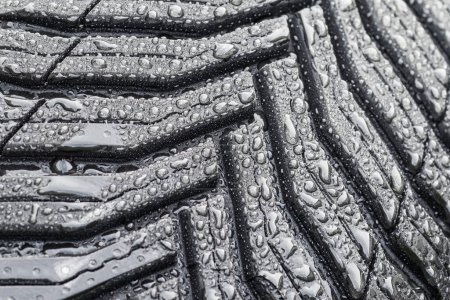 Photo for Closeup of the tire tread pattern. Car tyre tracks with waterdrops - Royalty Free Image