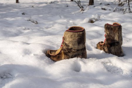 Photo for Scandinavian winter sami boots in the snow on a sunny day - Royalty Free Image