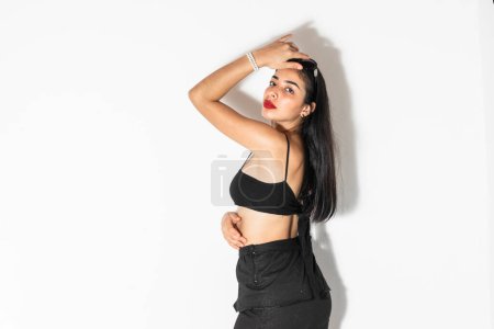 Photo for Portrait of young brown-skinned latina woman posing sideways with one hand on her head - Royalty Free Image