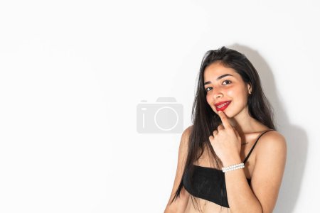 Photo for Close-up portrait of a beautiful latin teenage girl smiling on a white background - Royalty Free Image