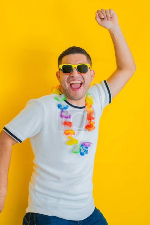 Photo for Young Latino man celebrating and shouting that his team won and triumphed, while jumping up and down and raising his hands - Royalty Free Image