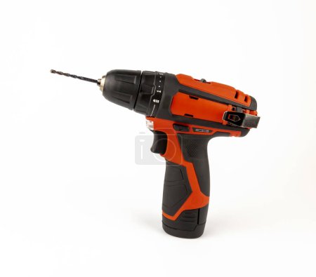 A cordless drill and a screwdriver. Red electric screwdriver on a white background. The concept of a cordless tool.