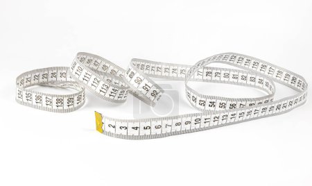 A measuring tape used by tailors for sewing clothes. Sewing concept