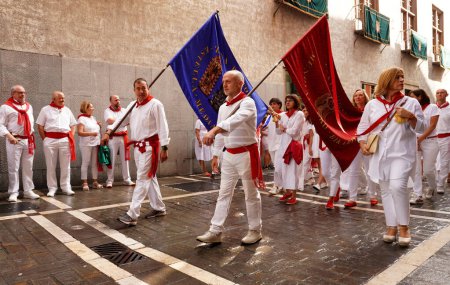 Téléchargez les photos : Procession de San Fermin.Les gens portent des drapeaux avec des images des saints de Pampelune Navarre. Espagne7 juillet 2023 - en image libre de droit