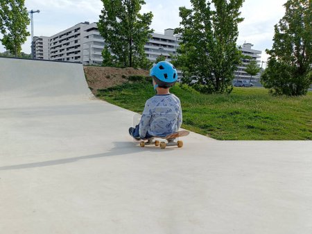 a child slides down a slide while sitting on a skateboard