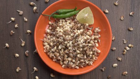 Foto de Close up view of sprouted soy with green peppers and lemon, healthy food concept - Imagen libre de derechos