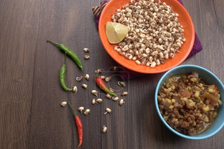 Foto de Close up view of raw and prepared sprouted soy with peppers and lemon, healthy food concept - Imagen libre de derechos