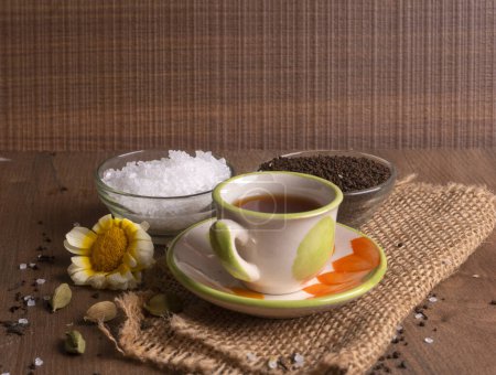 Photo for Indian masala tea in cup with spices on wooden background - Royalty Free Image