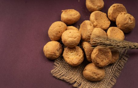 Photo for Homemade cookies with wheat and sackcloth on purple background - Royalty Free Image