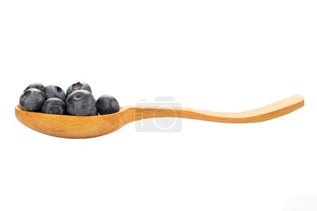 Wild blueberry in a wooden spoon isolated on a white background. The file contains a clipping path.