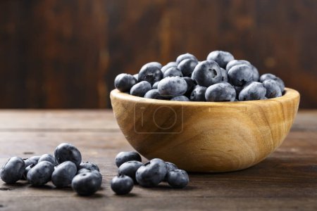 Fresh blueberries in a wooden bowl. Healthy and dietary food concept. Blueberry is an antioxidant.