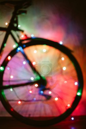 Téléchargez les photos : Vélo flou décoré avec des lumières de Noël hors foyer - en image libre de droit