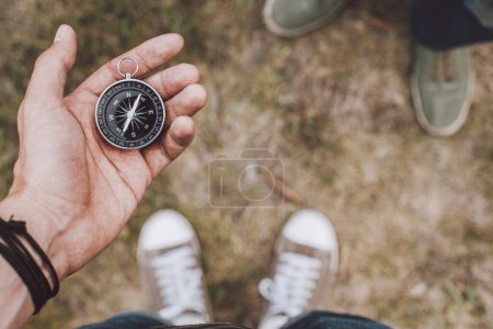 Téléchargez les photos : Hipster traveler holding compass in hand - en image libre de droit