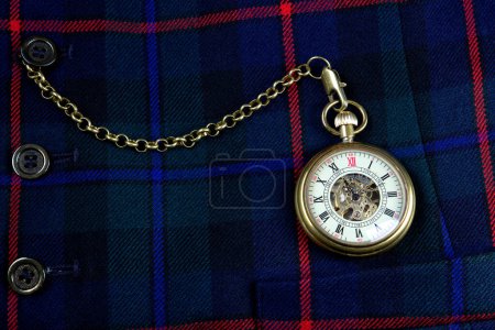Photo for Scottish tartan waistcoat with old pocket watch and chain closeup - Royalty Free Image