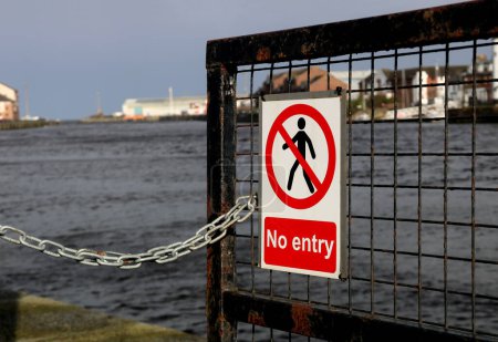 Pedestrian no entry warning sign at an urban river estuary location