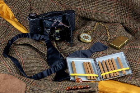 Tweed jacket with vintage camera pocket watch cigar case and brass lighter