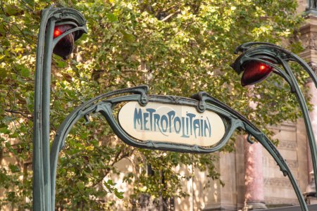 Photo for Paris, France. August 2022. Yellow retro style Metropolitain sign of the Paris subway network against a leafy green trees background. High quality photo - Royalty Free Image