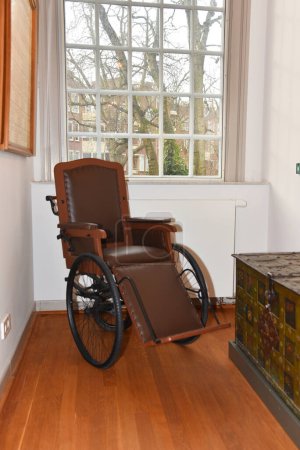 Foto de Ámsterdam, Países Bajos. 20 de enero de 2024. Una vieja silla de ruedas en la Casa Luther de Ámsterdam. Foto de alta calidad - Imagen libre de derechos