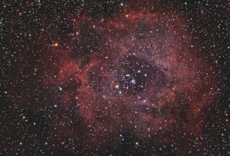 Photo for The Rosette Nebula located near one end of a giant molecular cloud in the Monoceros region of the Milky Way. Stars night sky backgrounds with 80mm refractor telescope - Royalty Free Image