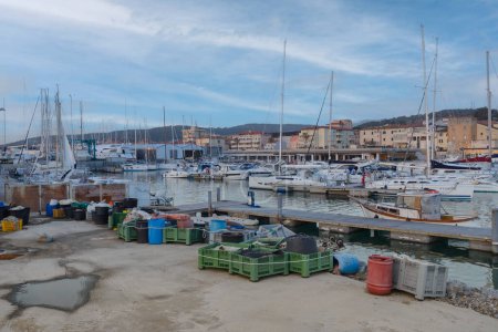 Photo for View of the city of San Vincenzo. Fishing nets in the port of San Vincenzo, Livorno, Tuscany, Italy - Royalty Free Image