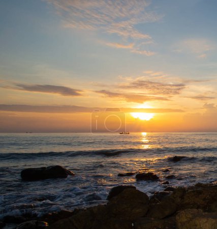 Photo for Rocks on the beach with sea and mountains in the background at sunset. - Royalty Free Image